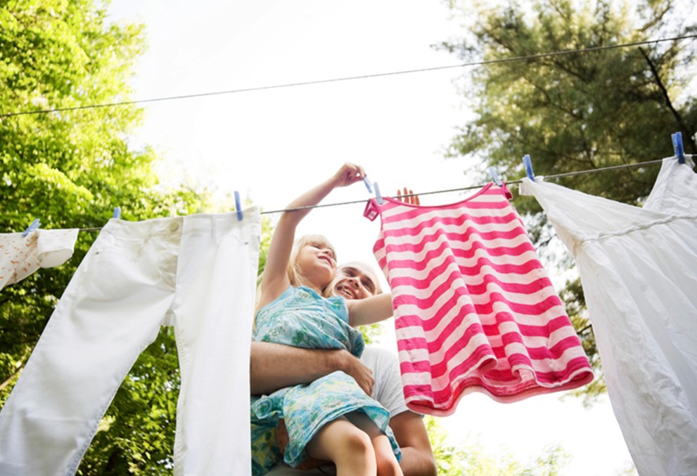 a kid handing washed clothes - PALMFONATE brand banner